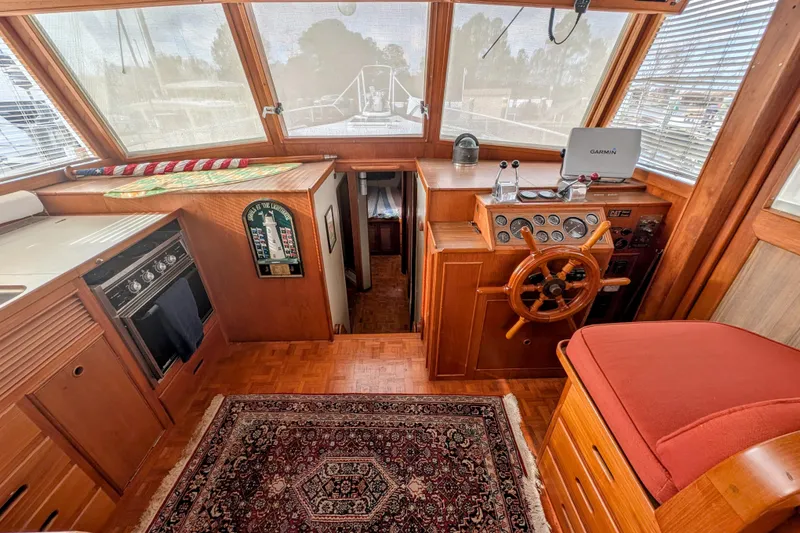 Slide: The Image of 1988 Grand Banks 46 Classic yacht interior with helm, wooden cabinetry, and navigation equipment. - 7