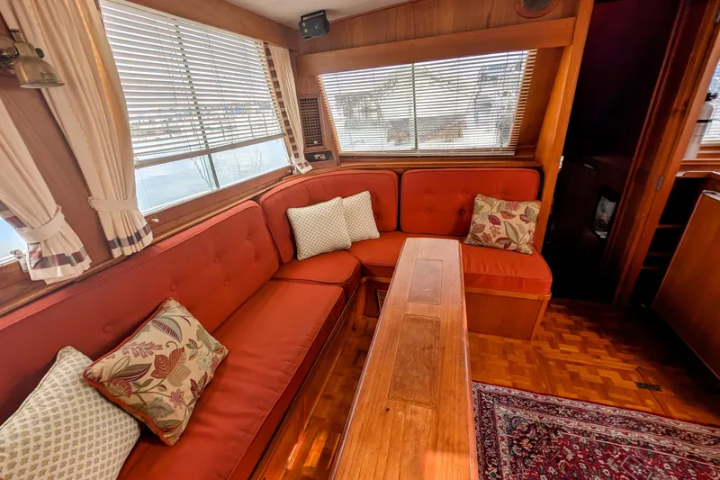 Slide: The Image of Interior of 1988 Grand Banks 46 Classic yacht with red seating and decorative pillows. - 8