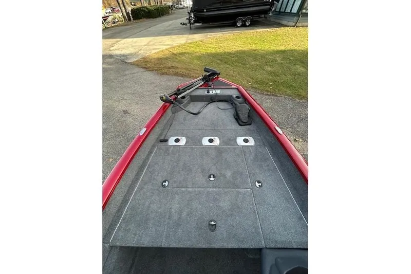 Slide: The Image of 2026 Tracker Pro Team 175 Crappie Edition boat deck with trolling motor, parked on pavement. - 57