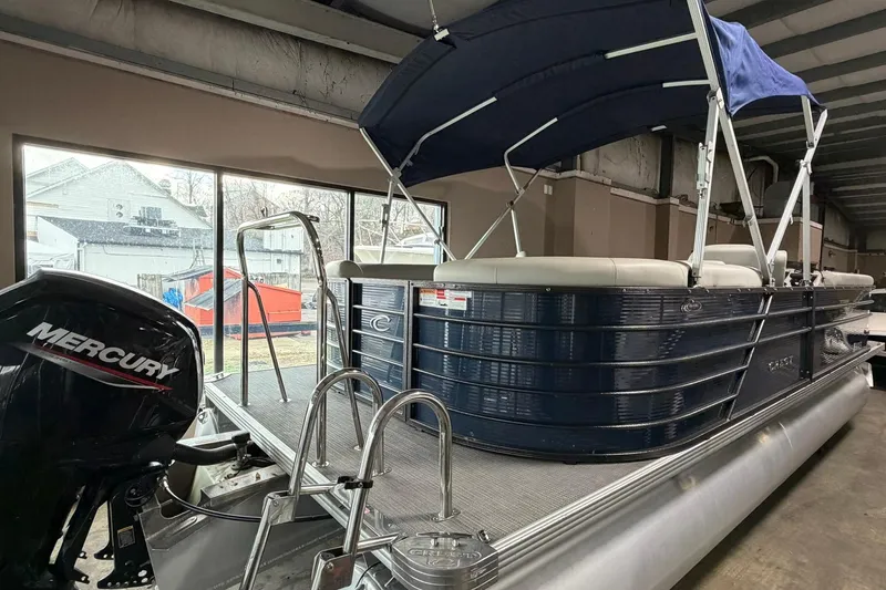 Slide: The Image of 2021 Crest Classic Platinum 240 SLC pontoon boat with Mercury engine in a showroom. - 12