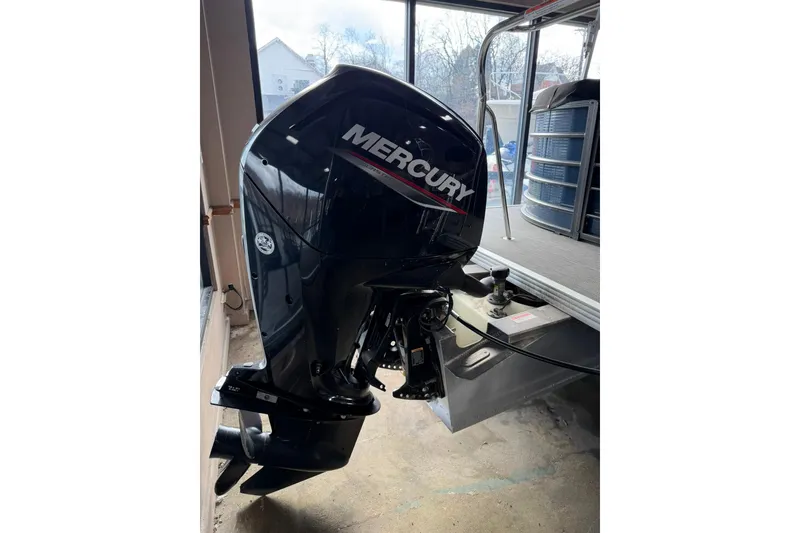 Slide: The Image of 2021 Crest Classic Platinum 240 SLC with Mercury outboard motor in showroom. - 14