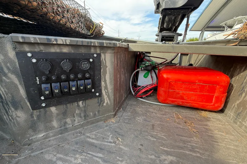 Slide: The Image of Control panel and red fuel tank in 2026 War Eagle 750 Gladiator boat. - 12