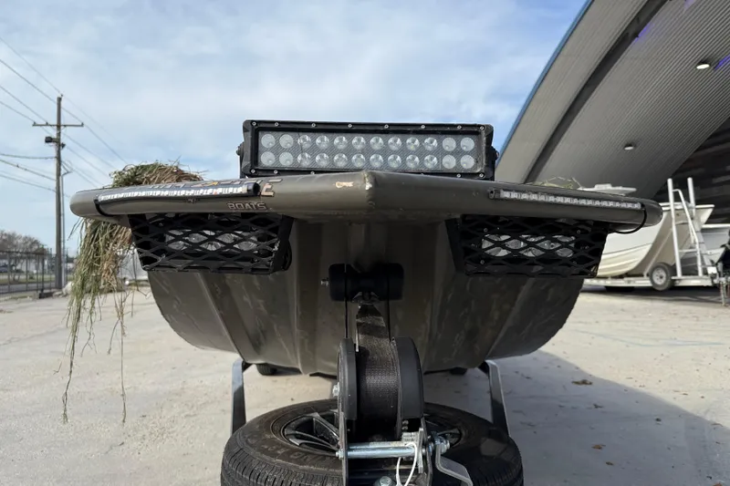 Slide: The Image of 2026 War Eagle 750 Gladiator boat on trailer, featuring LED lights and storage baskets. - 3