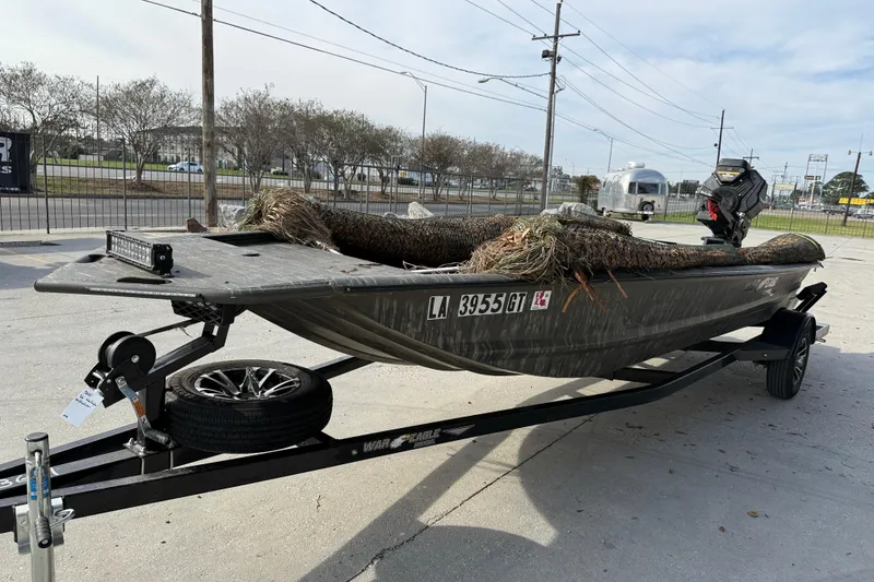 Slide: The Image of 2026 War Eagle 750 Gladiator boat on trailer, equipped with camouflage cover. - 4