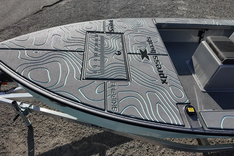 Slide: The Image of 2026 Xpress Skiff 185 boat with sleek design and modern features, viewed from above. - 11