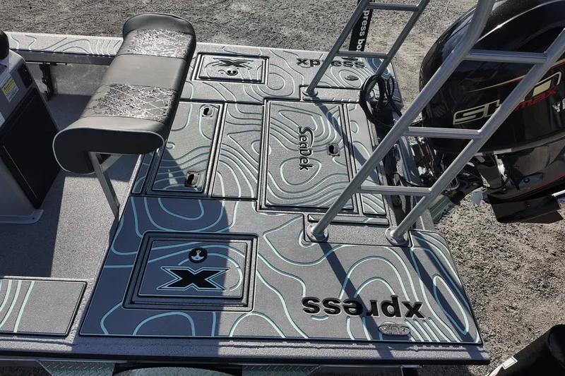 Slide: The Image of 2026 Xpress Skiff 185 boat with modern design and detailed topographic pattern. - 13