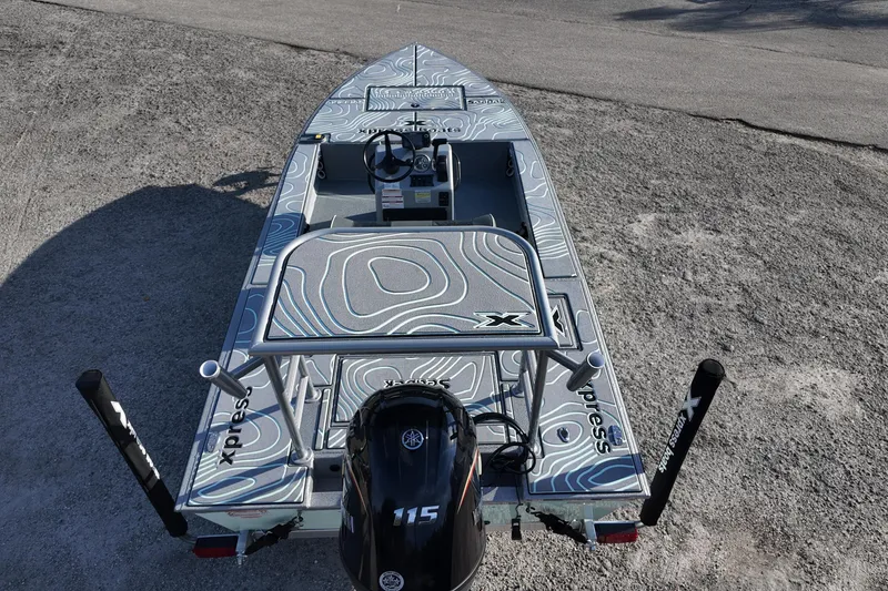 Slide: The Image of 2026 Xpress boat deck with stylish seating and ladder, featuring SeaDek flooring. - 16