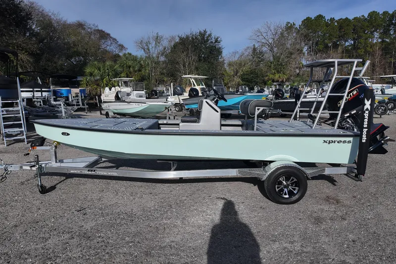Slide: The Image of 2026 Xpress Skiff 185 boat with Yamaha engine on trailer in outdoor setting. - 3
