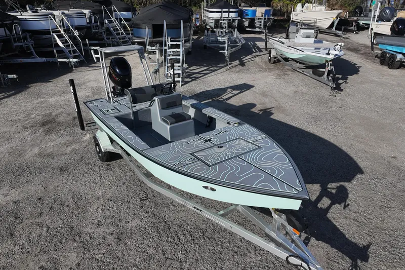 Slide: The Image of 2026 Xpress Skiff 185 boat with sleek design and modern steering console. - 5