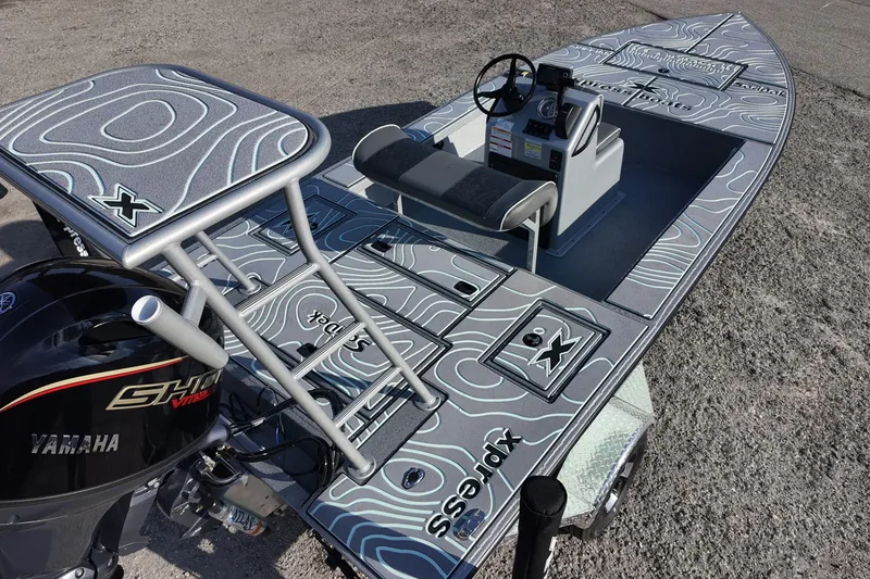 Slide: The Image of Open storage compartment on 2026 Xpress boat with textured surface design. - 7