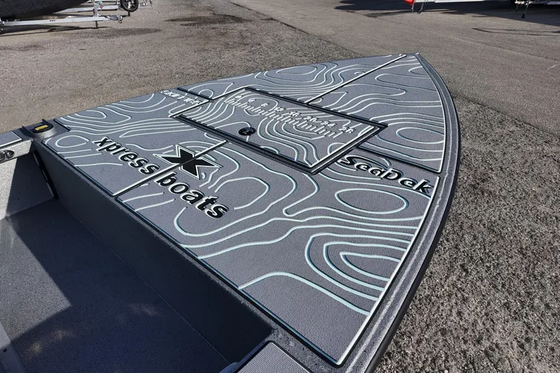 Slide: The Image of 2026 Xpress Skiff 185 boat with Minn Kota Terrova motor in a marina setting. - 9