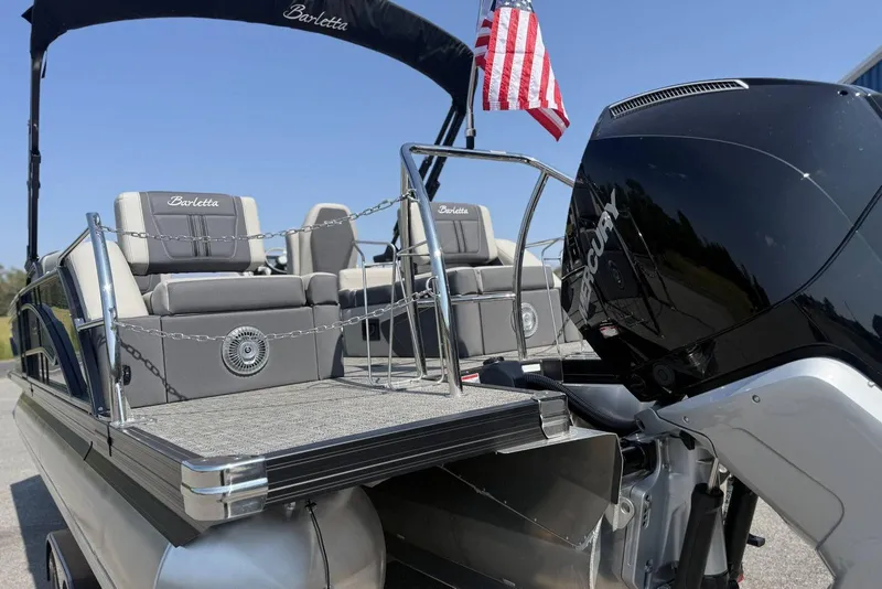 Slide: The Image of 2025 Barletta CORSA 25M pontoon boat with Mercury engine and American flag. - 3