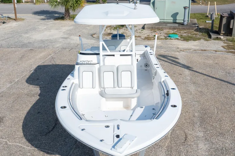 Slide: The Image of 2020 Sea Fox 249 Avenger boat, white interior, parked on concrete surface. - 11