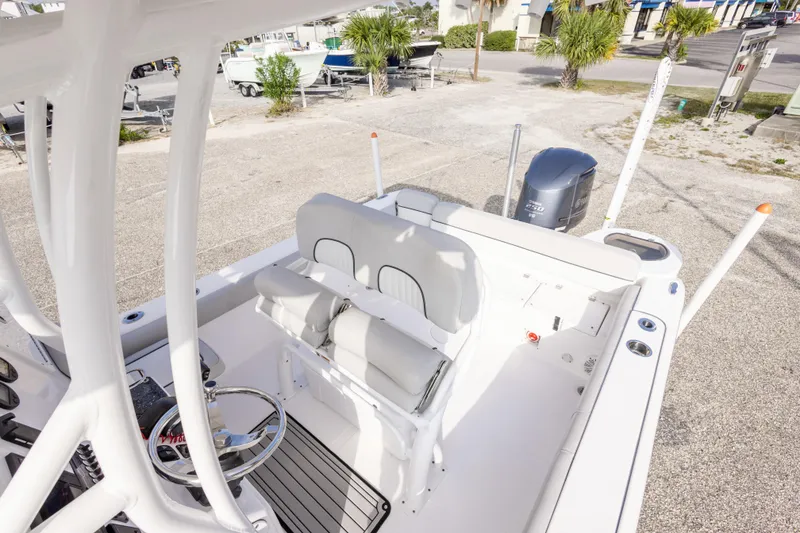 Slide: The Image of 2020 Sea Fox 249 Avenger boat interior with seating and steering wheel, parked outdoors. - 21