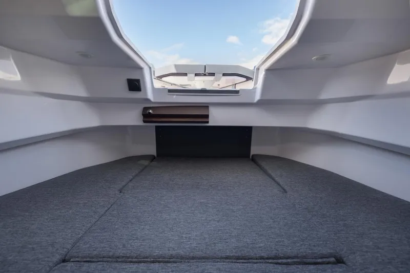 Slide: The Image of Interior cabin view of 2026 Axopar 29 XC Cross Cabin with skylight and cushioned seating. - 25