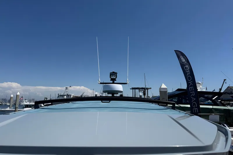 Slide: The Image of 2026 Axopar 29 XC Cross Cabin at marina with clear blue sky. - 16