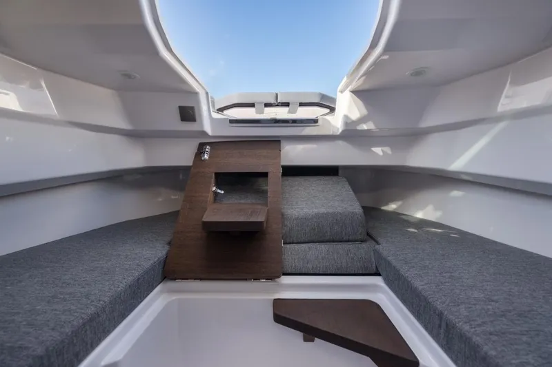 Slide: The Image of Interior of 2026 Axopar 29 XC Cross Cabin with modern seating and wooden accents. - 26