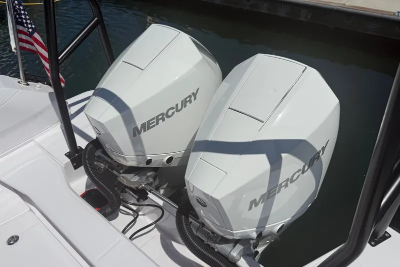 Slide: The Image of Twin Mercury outboard engines on a 2026 Axopar 29 XC Cross Cabin boat. - 14