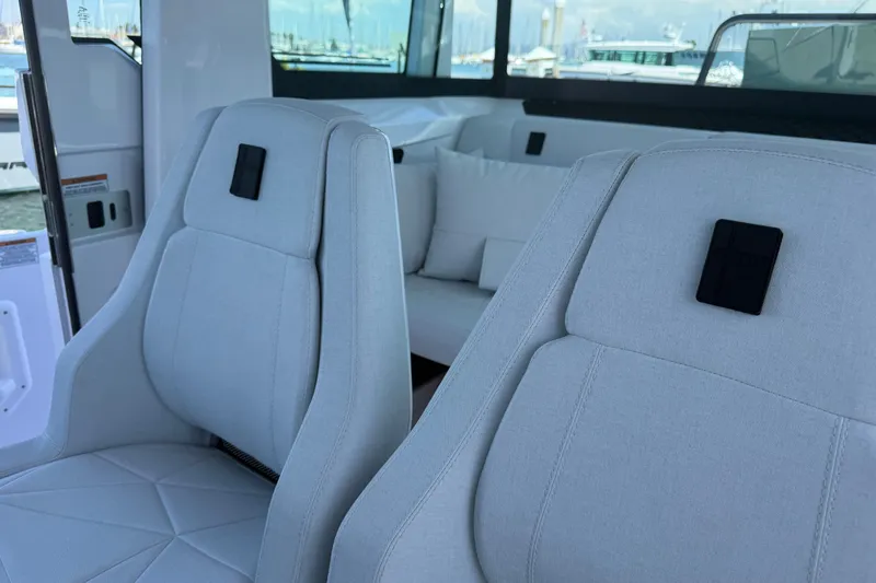 Slide: The Image of Interior of 2026 Axopar 29 XC Cross Cabin with modern seating and windows. - 18