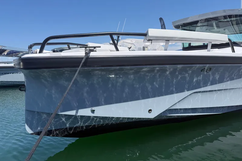 Slide: The Image of 2026 Axopar 29 XC Cross Cabin boat docked on calm water. - 15