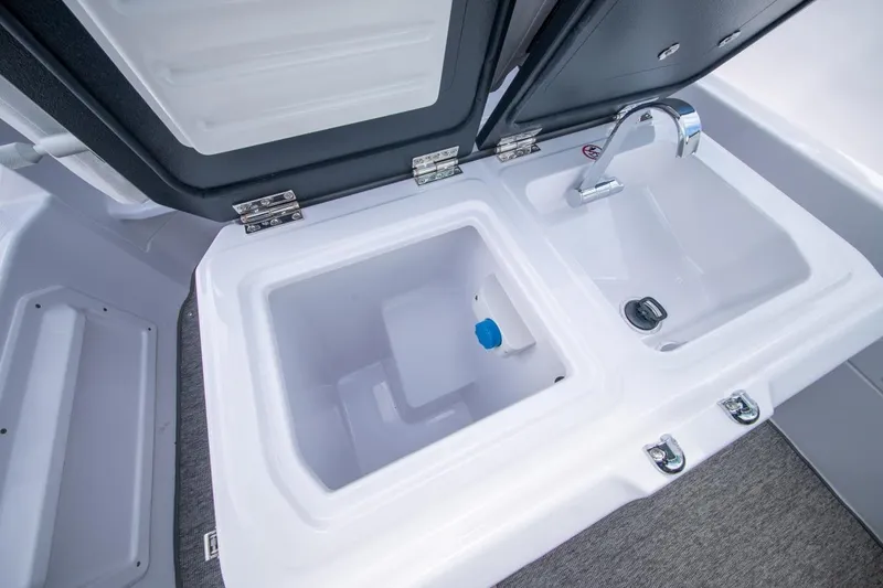 Slide: The Image of 2026 Axopar 29 XC Cross Cabin sink and storage compartment detail. - 19