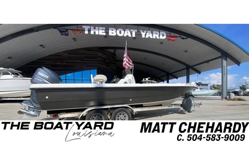 Slide: The Image of 2000 Sprint 221 boat with Yamaha engine on trailer at boat yard. - 1