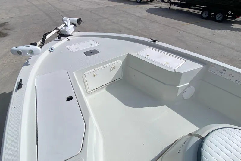 Slide: The Image of 2000 Sprint 221 boat on concrete lot, featuring spacious deck and seating. - 10