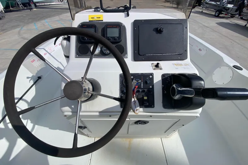 Slide: The Image of Open deck of a 2000 Sprint 221 boat with seating and control console. - 14