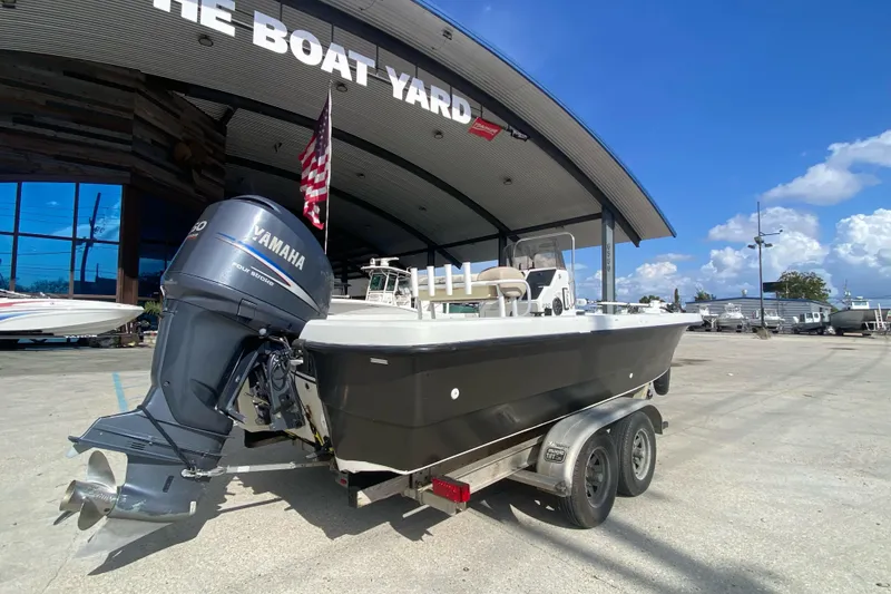 Slide: The Image of Boat with 250 horsepower engine, Sprint 221 model, year 2000, in a marina setting. - 2