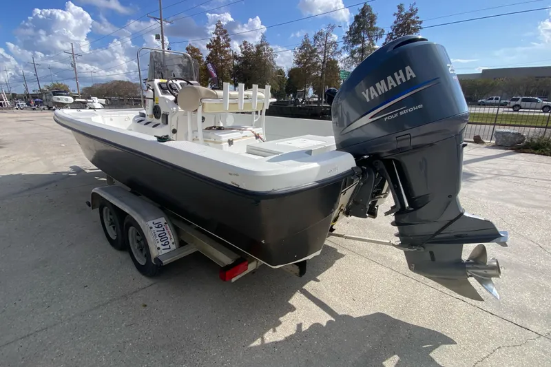 Slide: The Image of 2000 Sprint 221 boat on trailer with Yamaha motor, parked outdoors. - 4