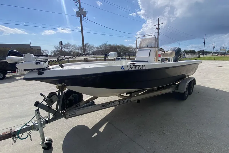 Slide: The Image of 2000 Sprint 221 boat on trailer in outdoor storage area. - 6