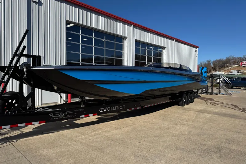 Slide: The Image of MTI 440X 2025 speedboat on trailer outside a modern industrial building. - 1