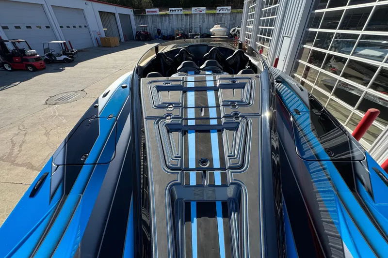 Slide: The Image of 2025 MTI 440X powerboat with sleek design and blue accents in a garage setting. - 11