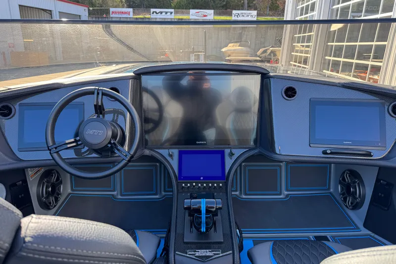 Slide: The Image of 2025 MTI 440X boat dashboard with advanced navigation screens and steering wheel. - 15