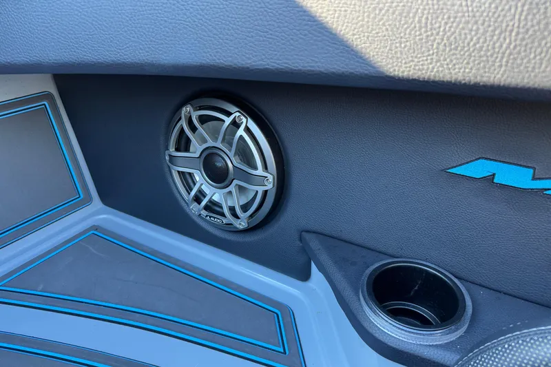 Slide: The Image of Interior of 2025 MTI 440X featuring speaker and cup holder with blue accents. - 22