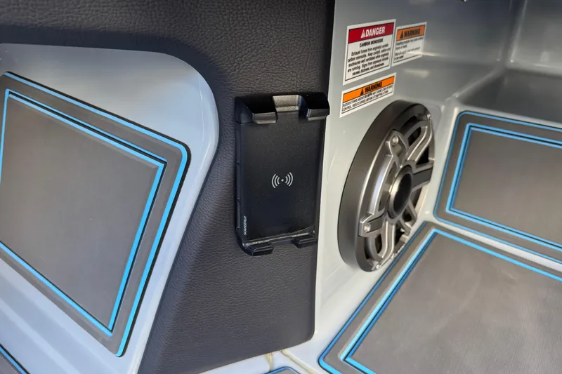 Slide: The Image of Interior of 2025 MTI 440X with speaker, phone holder, and warning labels. - 23