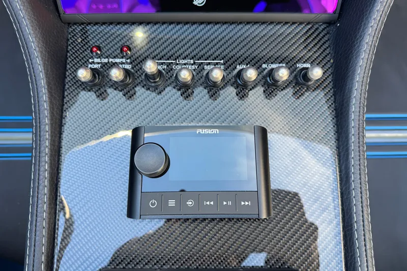 Slide: The Image of Carbon fiber dashboard with control panel and Fusion audio system in MTI 440X, 2025 model. - 24