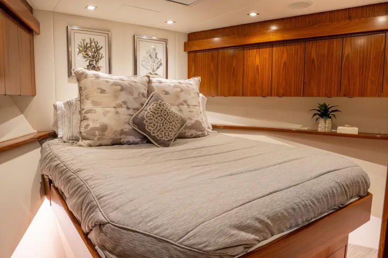 Slide: The Image of Luxurious bedroom interior on 2018 Viking 80 Enclosed Bridge yacht with elegant wood finishes. - 18