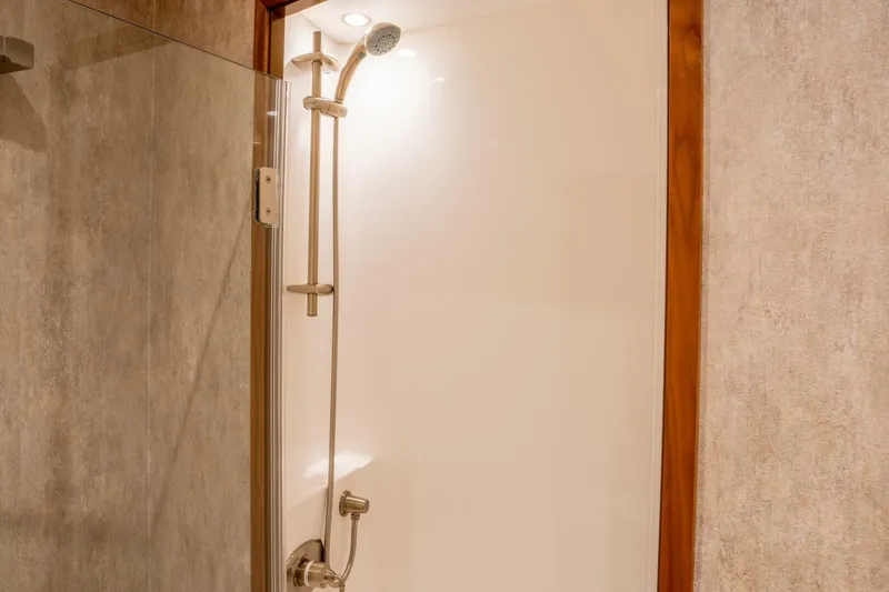 Slide: The Image of Shower area inside 2018 Viking 80 Enclosed Bridge yacht, featuring modern fixtures and glass door. - 19
