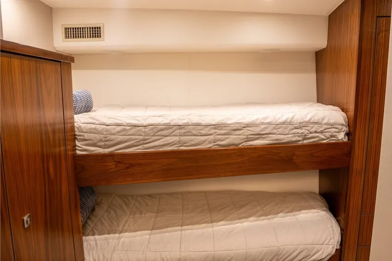 Slide: The Image of Bunk beds in 2018 Viking 80 Enclosed Bridge yacht cabin with wooden finish. - 24