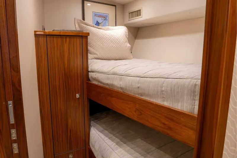 Slide: The Image of Bunk beds in 2018 Viking 80 Enclosed Bridge yacht cabin with wooden cabinetry. - 25