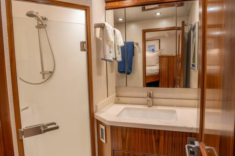 Slide: The Image of Luxurious bathroom in 2018 Viking 80 Enclosed Bridge yacht with modern shower and sink. - 26