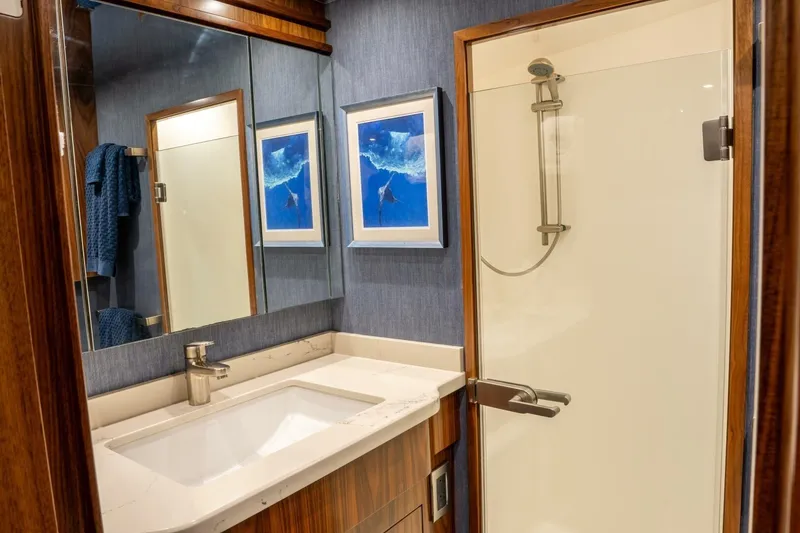 Slide: The Image of Luxurious bathroom in 2018 Viking 80 Enclosed Bridge yacht with modern shower and elegant decor. - 30