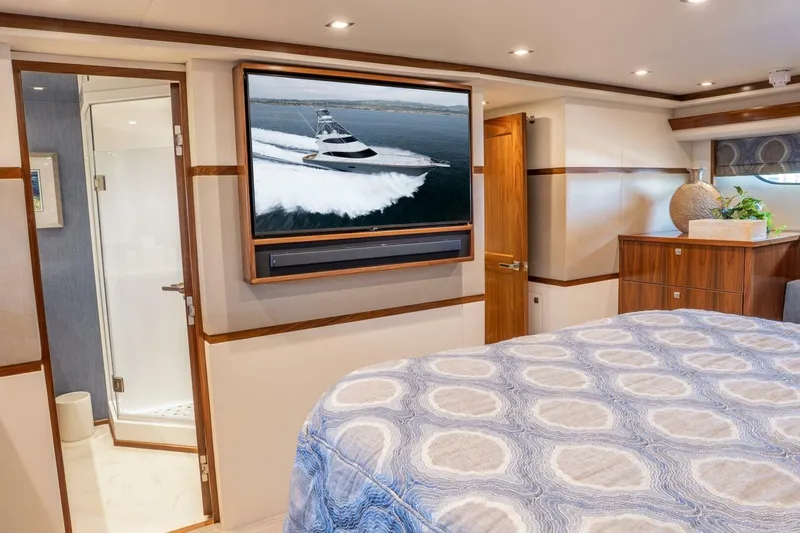 Slide: The Image of Luxurious bedroom interior of 2018 Viking 80 Enclosed Bridge yacht with TV and ensuite bathroom. - 35