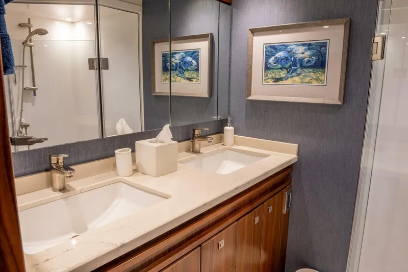 Slide: The Image of Luxurious bathroom in 2018 Viking 80 Enclosed Bridge yacht with dual sinks and elegant decor. - 38