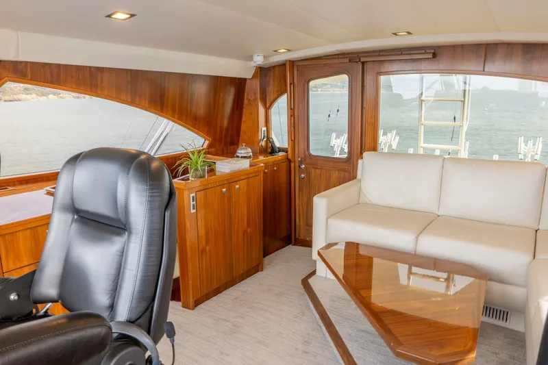 Slide: The Image of Luxurious interior of 2018 Viking 80 Enclosed Bridge yacht with leather chair and sofa. - 42