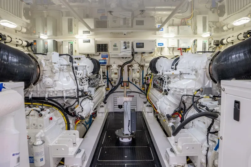 Slide: The Image of Engine room of 2018 Viking 80 Enclosed Bridge yacht, showcasing dual engines and control systems. - 45