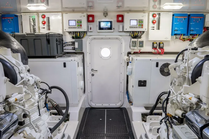 Slide: The Image of Engine room of 2018 Viking 80 Enclosed Bridge yacht, featuring advanced control panels and machinery. - 49