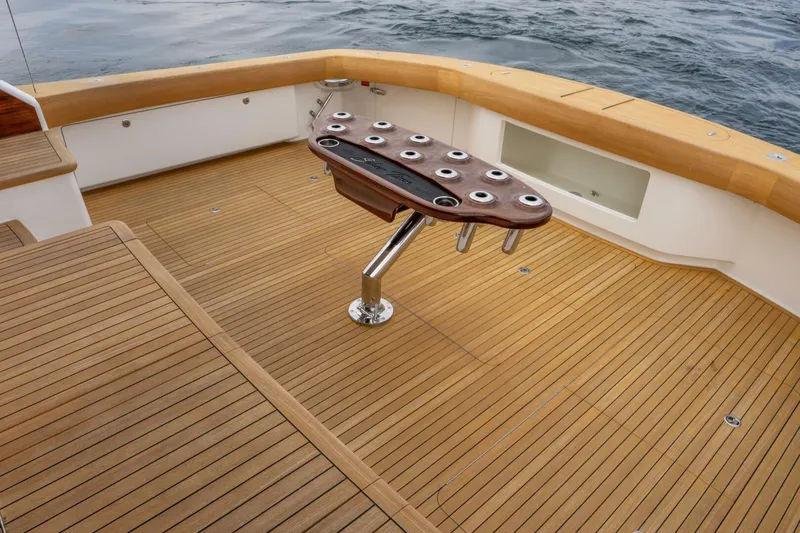 Slide: The Image of 2018 Viking 80 Enclosed Bridge yacht with teak deck and fishing rod holders. - 56
