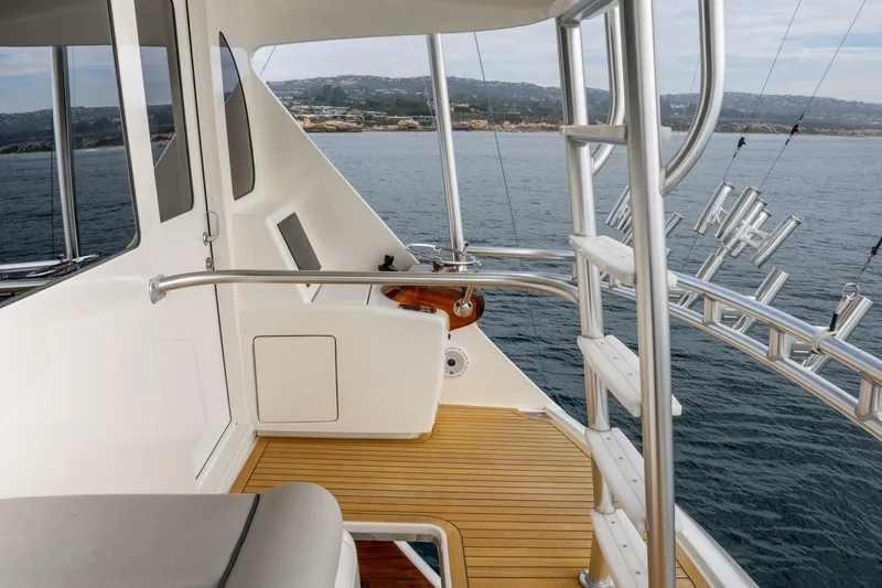 Slide: The Image of 2018 Viking 80 Enclosed Bridge yacht deck with ocean view and sleek design. - 58